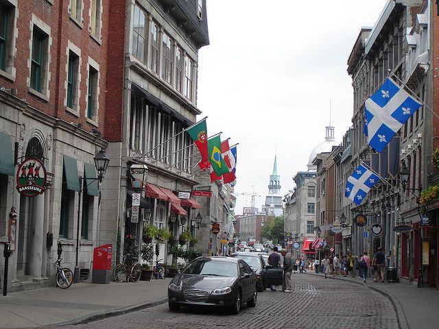 Colorful flags and cobblestones set apart Rue Saint-Paul in Old Montreal
