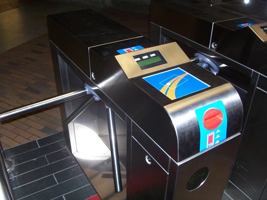 Fare reader and turnstile on the Montreal Metro. If you are using the Occasional fare card just place it against the card outline on the blue square at the top of the turnstyle. 