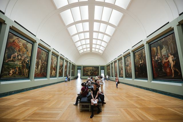 One of many expansive halls exhibiting paintings by the masters inside The Louvre
