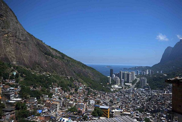 A favela spills down the hillside where it suddenly gives way to the oppulent highrises by the water