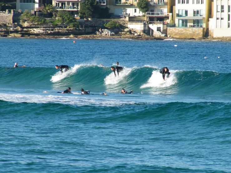 Surfers catching a wave at Bondi Beach
