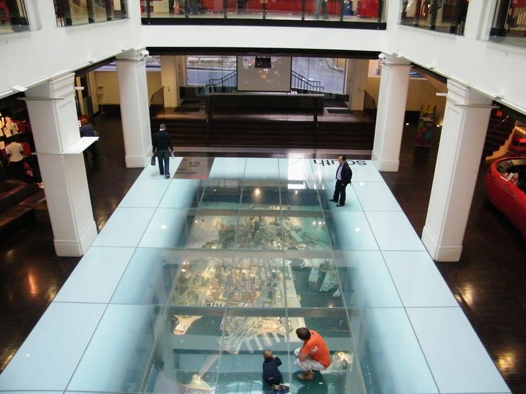 Visitors check out the spectacular model of Sydney under the glass floor inside the Customs House