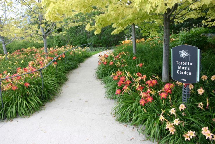 A flower lined pathway invites visitors into the Toronto Music Garden