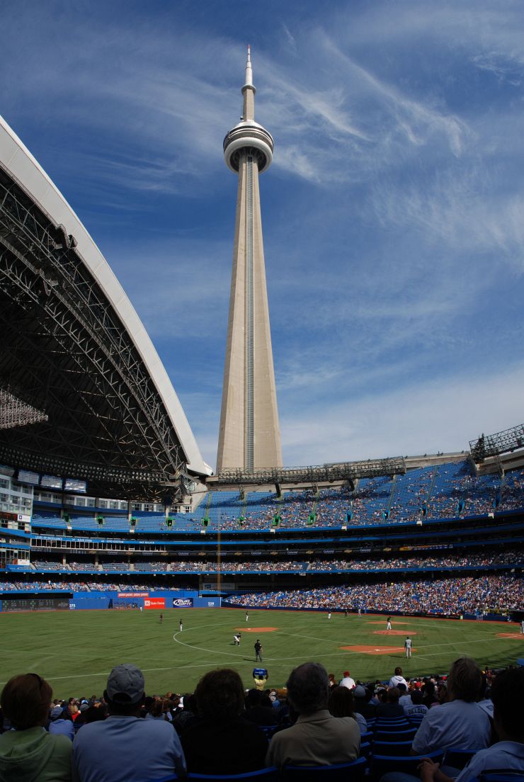 Baseball game at Rogers Centre with open roof and CN Tower behind