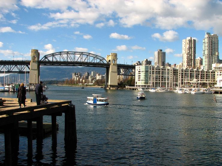 A False Creek Ferry Passing Granville Island with Burrard Street Bridge in the background
