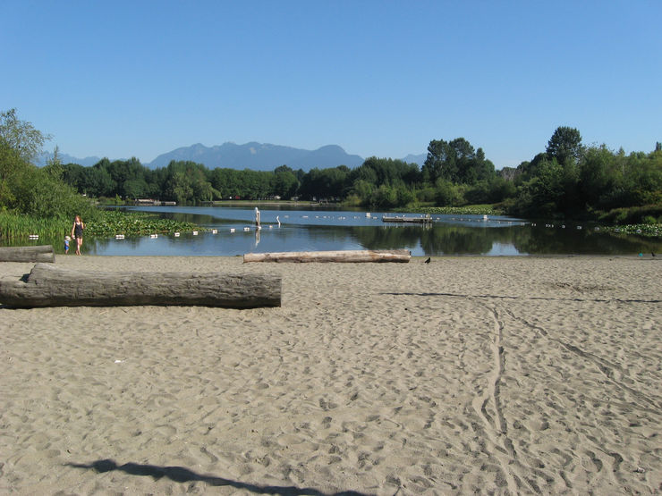 A sandy beach flanks the south end of Trout Lake in John Hendry Park