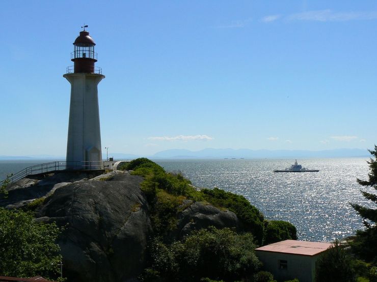 A BC Ferry passes by the Lighthouse in Lighthouse Park