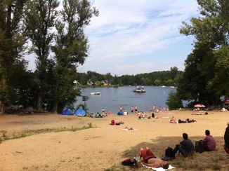 Sunbathers enjoying a sunny day on the beach at Muggelsee