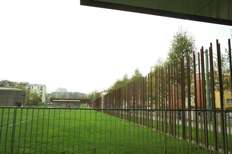 A portion of the Berlin Wall Memorial along Bernauer Strasse with the Chapel of Reconciliation in the background