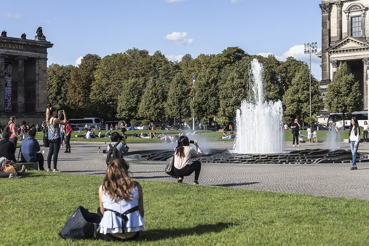 Locals and visitors relax around the fountain in Lustgarten Berlin