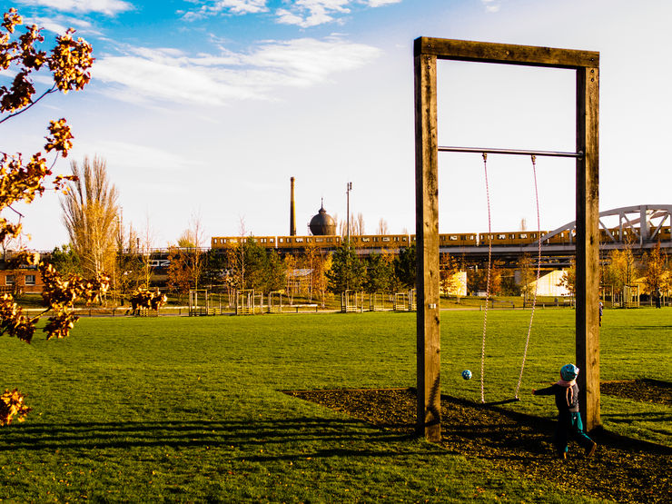 Playground area in the Park at Gleisdreieck with U-Bahn train in the background