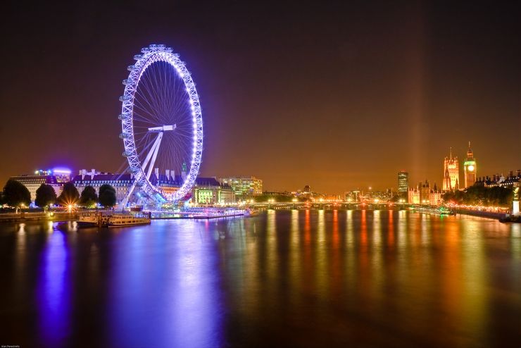 The Huge London Eye Rotating Slowly Above the River Thames at Dusk