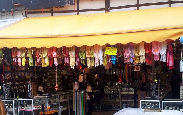 Colorful goods hang is a stall at Le Marché aux Puces de St-Ouen in Paris