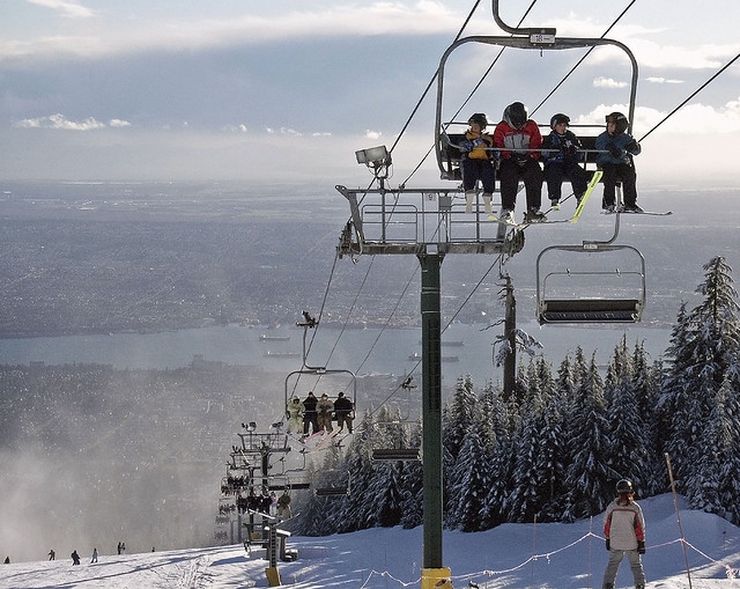 Enjoying spectacular views of the city along with winter sports on top of Grouse Mountain